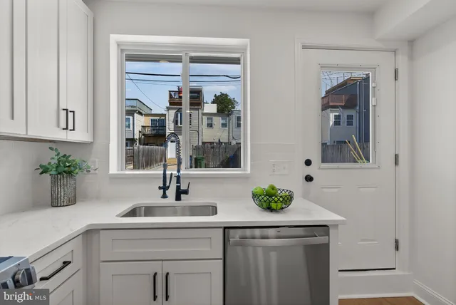 a kitchen with refrigerator and cabinets