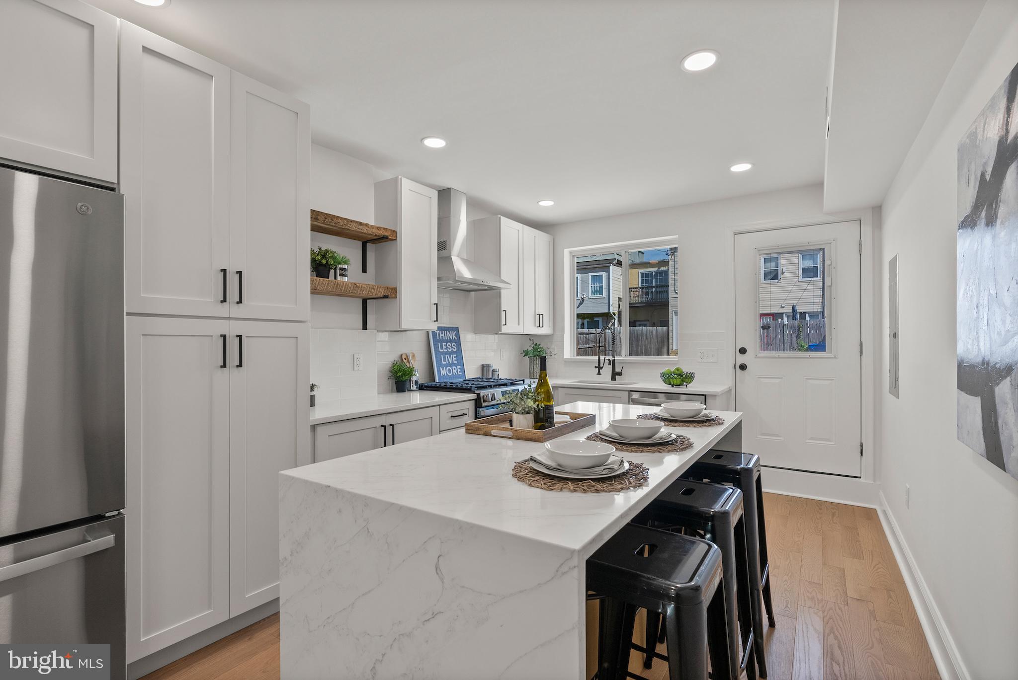 1523 Clarkson Street Baltimore, MD 21230 - Photo 22 of 57 a kitchen with white cabinets and refrigerator