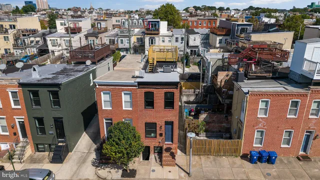 a front view of a house with a tree