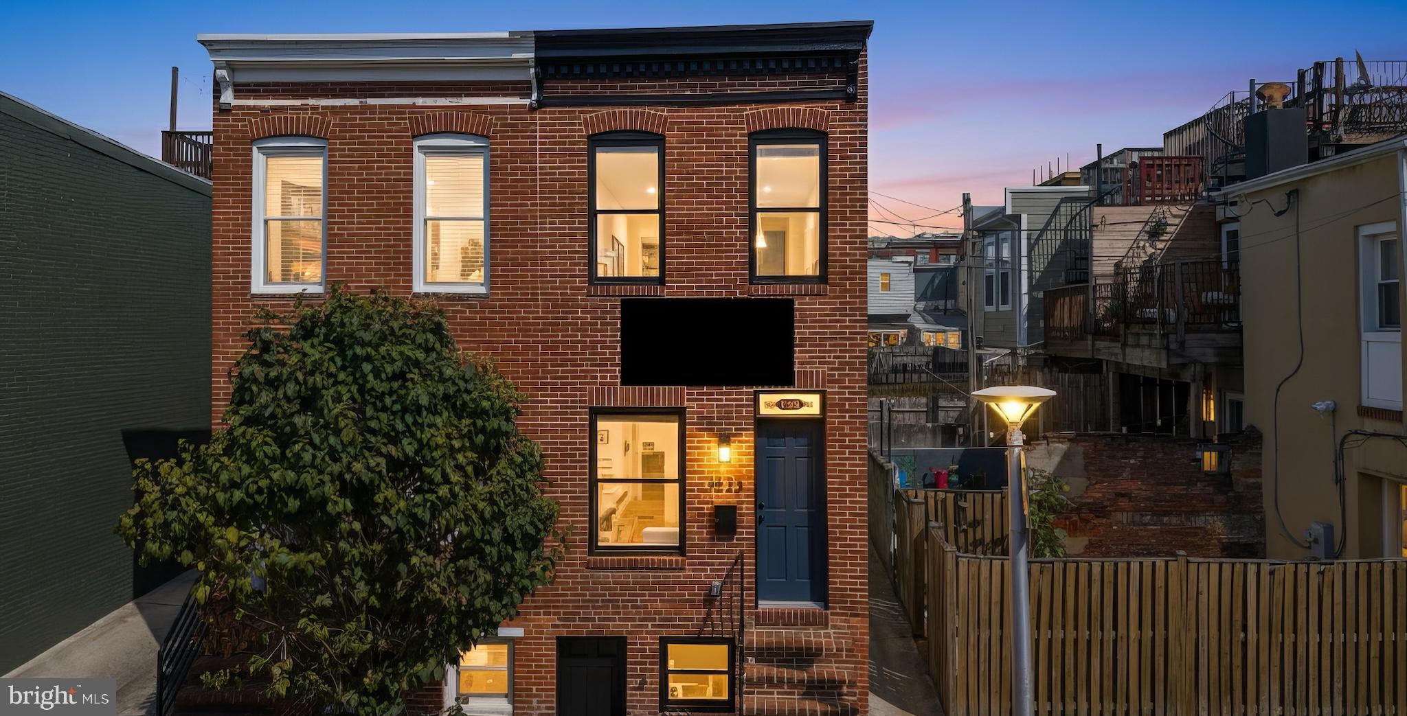 1523 Clarkson Street Baltimore, MD 21230 - Photo 3 of 57 a front view of a house with a yard