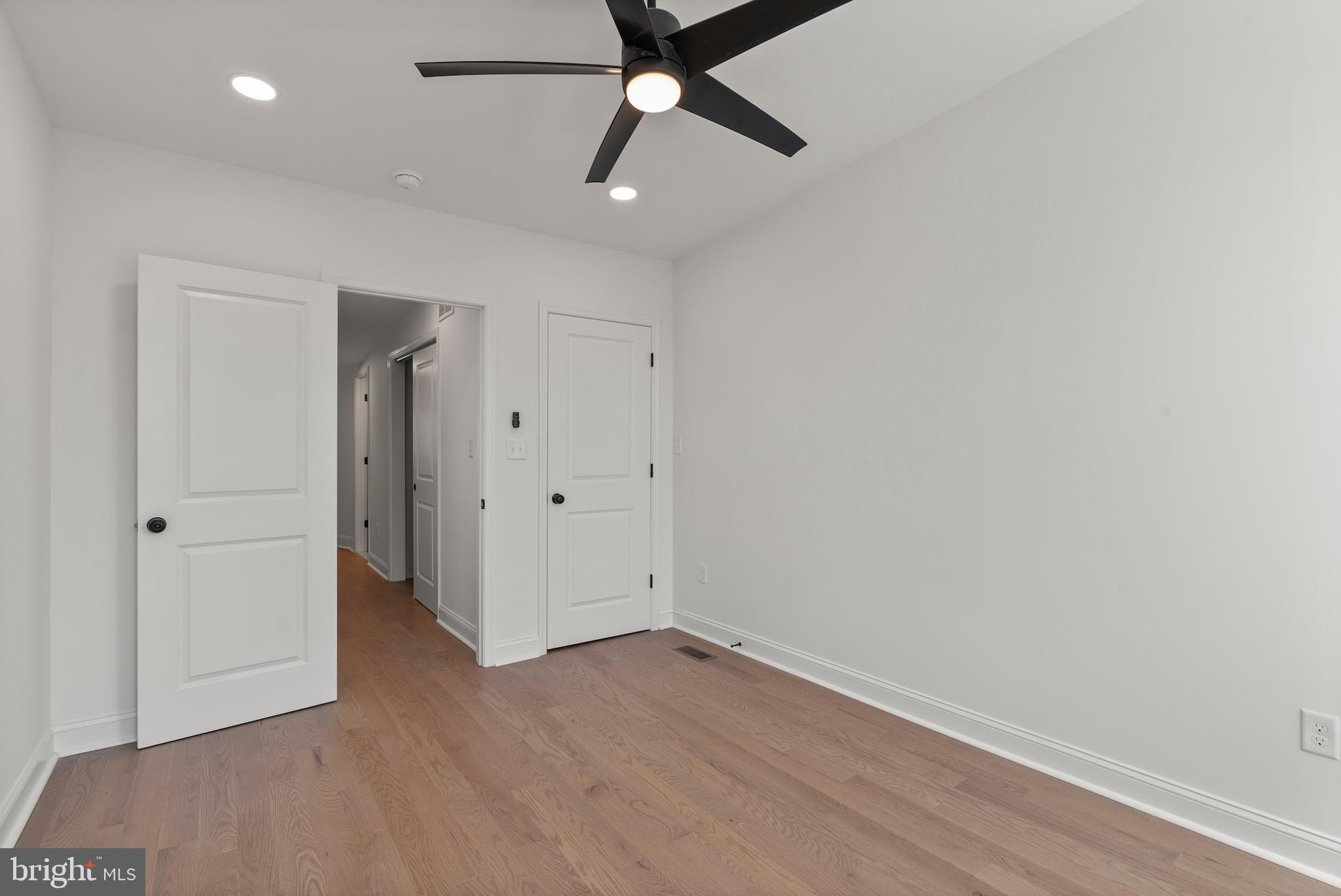 1523 Clarkson Street Baltimore, MD 21230 - Photo 42 of 57 an empty room with a ceiling fan and carpet