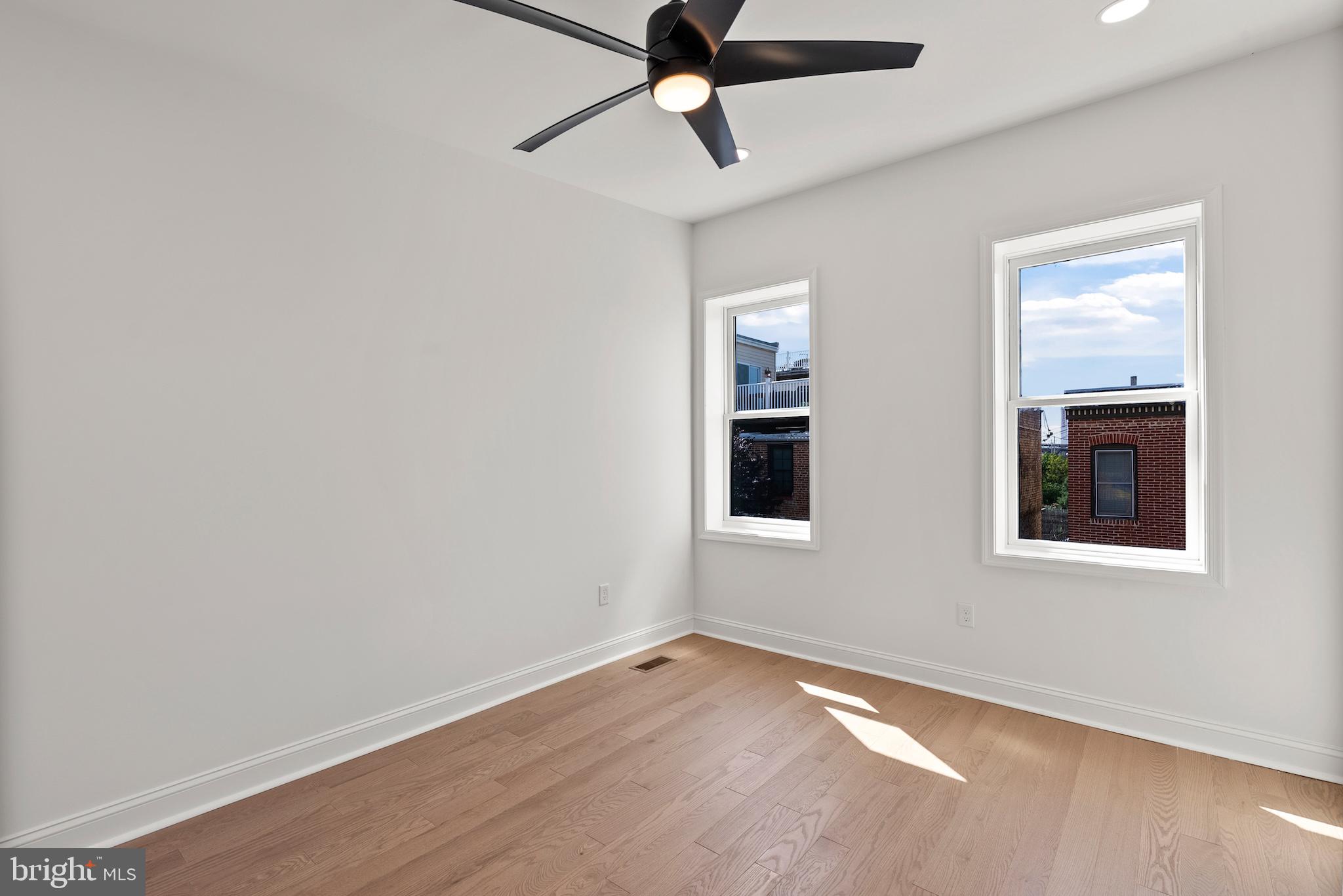 1523 Clarkson Street Baltimore, MD 21230 - Photo 43 of 57 wooden floor in an empty room with a window