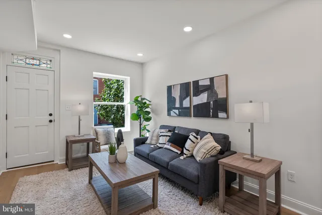 a living room with furniture and wooden floor