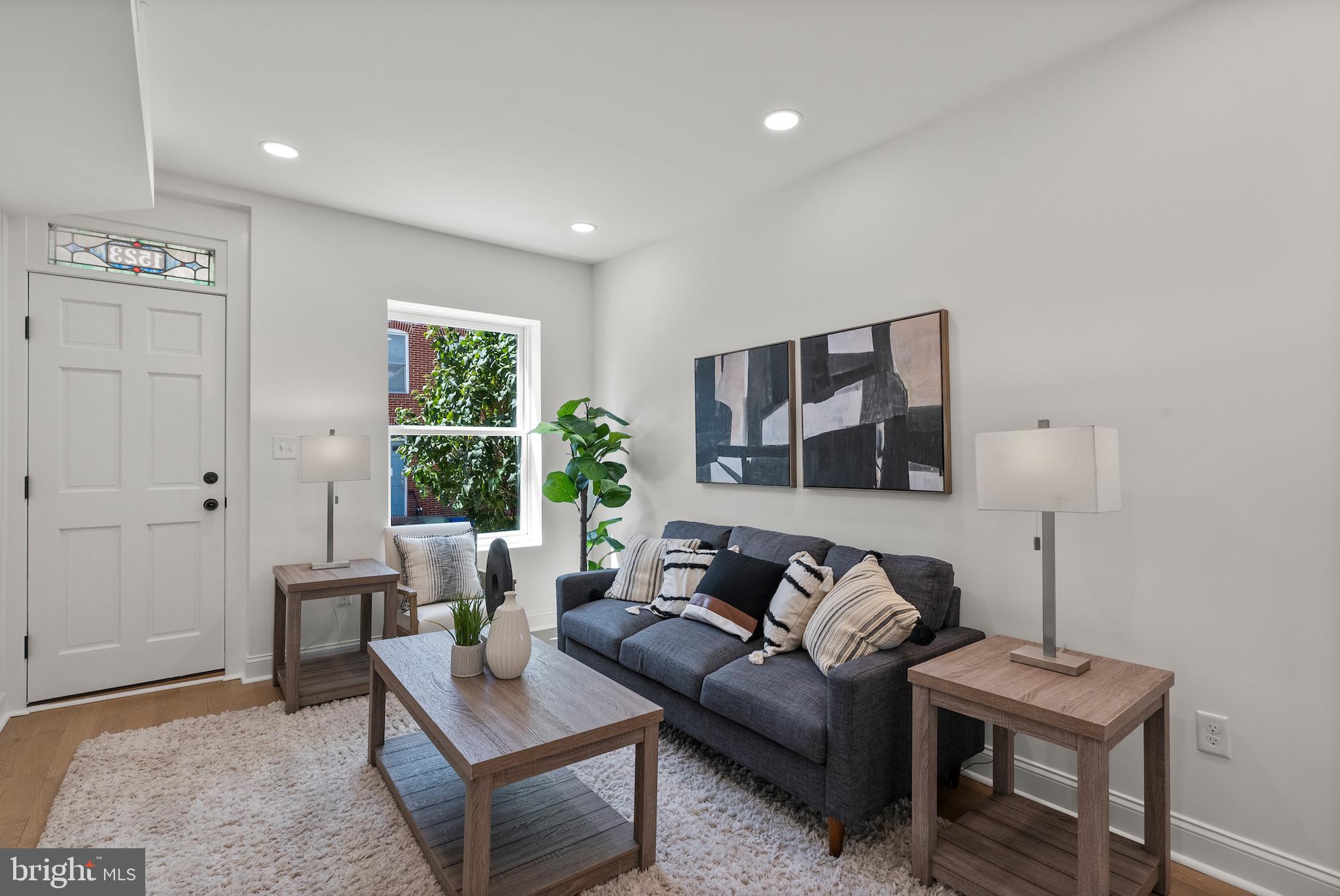 1523 Clarkson Street Baltimore, MD 21230 - Photo 8 of 57 a living room with furniture and a large window