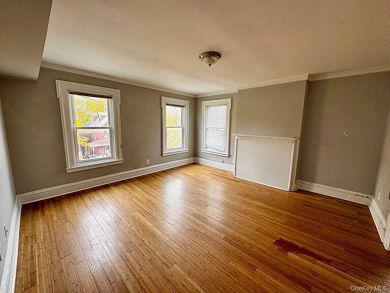 9 South Clinton Street, Unit 2 Poughkeepsie, NY 12601 - Photo 2 of 10 a view of empty room with wooden floor and fan