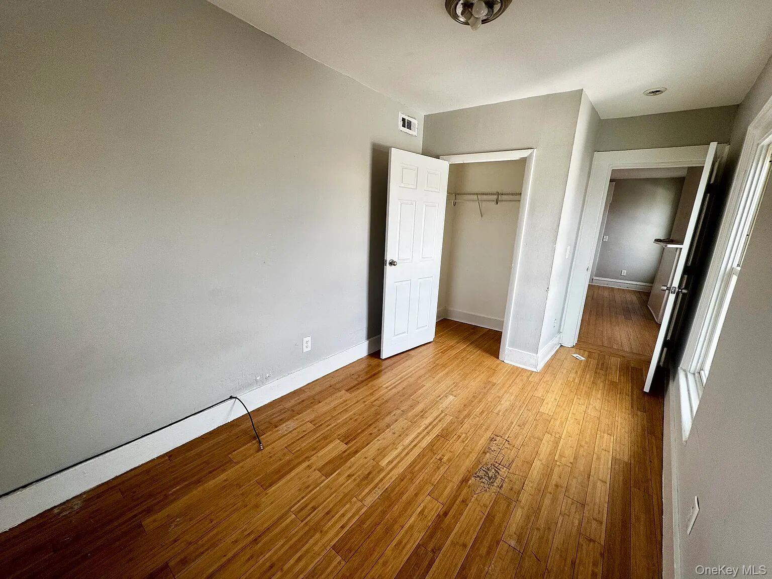 9 South Clinton Street, Unit 2 Poughkeepsie, NY 12601 - Photo 7 of 10 a view of an empty room with wooden floor and a window