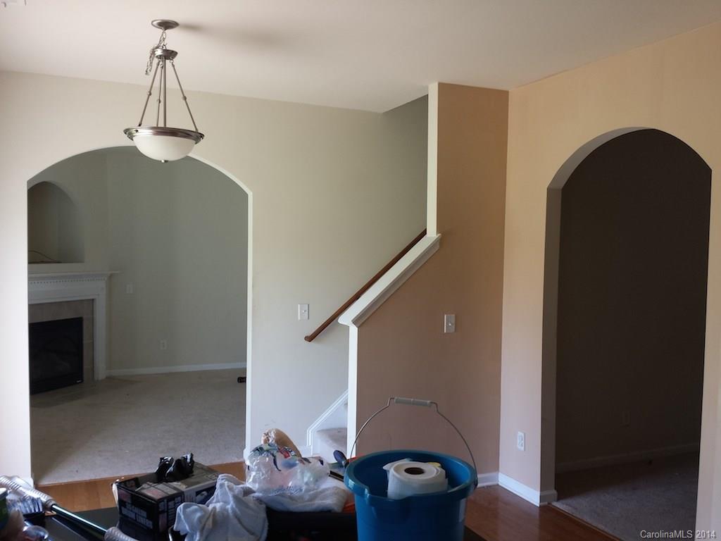 4084 Clover Road Northwest Concord, NC 28027 - Photo 3 of 17 a living room with furniture and a chandelier