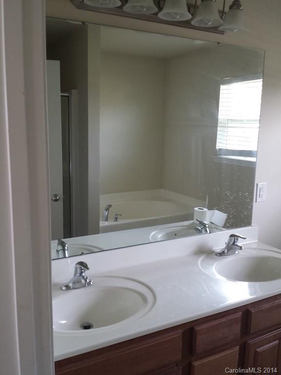 4084 Clover Road Northwest Concord, NC 28027 - Photo 7 of 17 a bathroom with a sink and a mirror