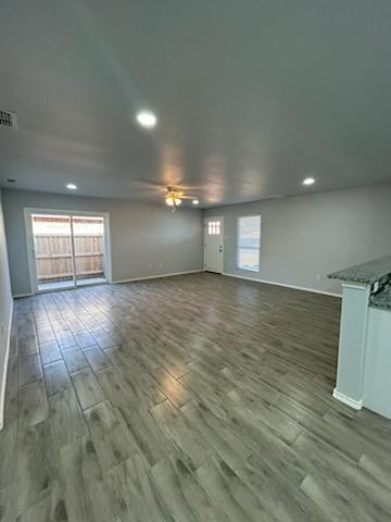 8612 10th Street Lubbock, TX 79416 - Photo 4 of 10 a view of empty room with wooden floor and fan