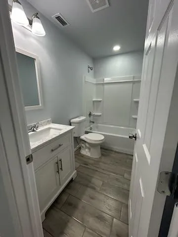 a bathroom with a double vanity sink mirror and toilet