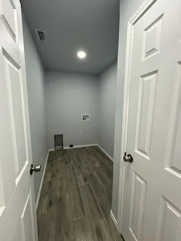 wooden floor and utility room with a sink