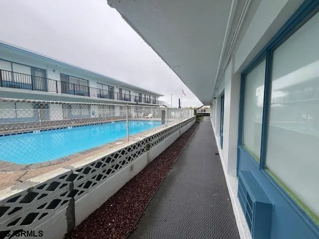 a view of swimming pool with an outdoor seating