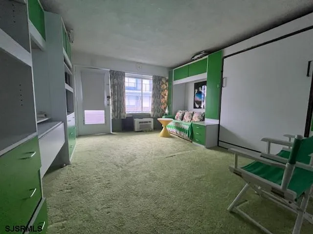 a living room with furniture a window and a flat screen tv