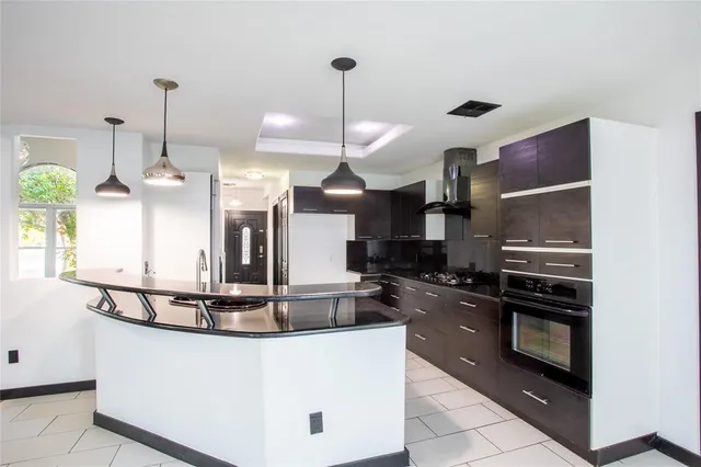 a kitchen with kitchen island a counter top space appliances and cabinets