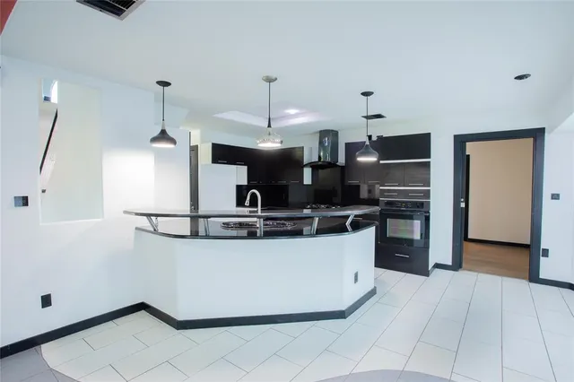 a kitchen with stainless steel appliances granite countertop a sink and a stove