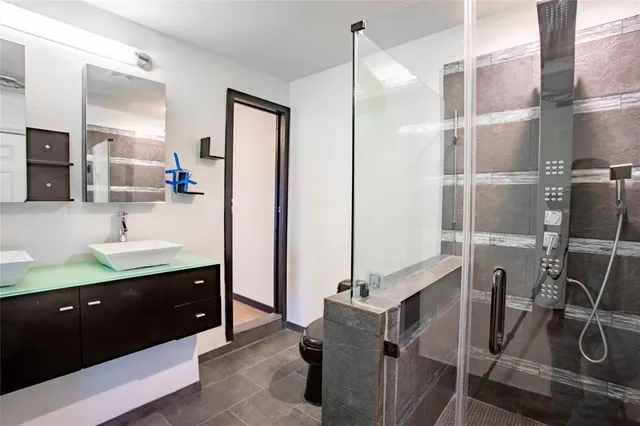 a bathroom with double vanity sink and mirror