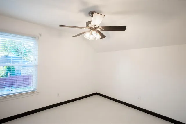 a view of a small space with a window and a ceiling fan