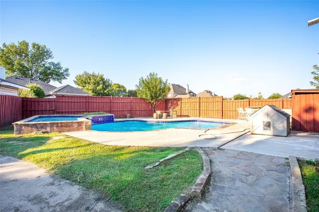 a view of a swimming pool with a yard