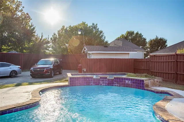 a backyard of a house with table and chairs