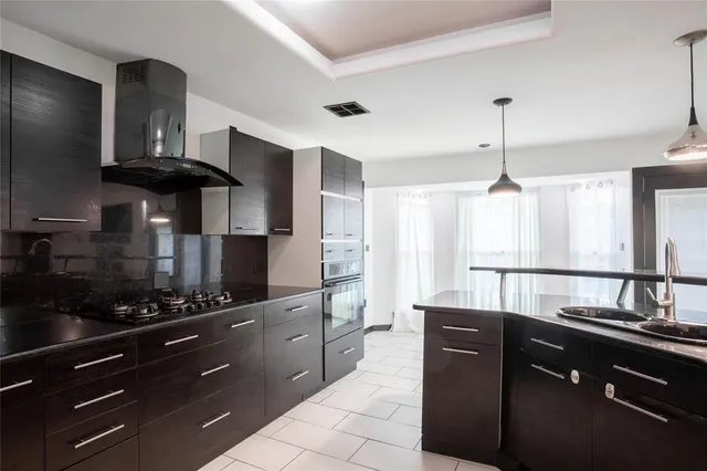 a kitchen with a sink stainless steel appliances and cabinets