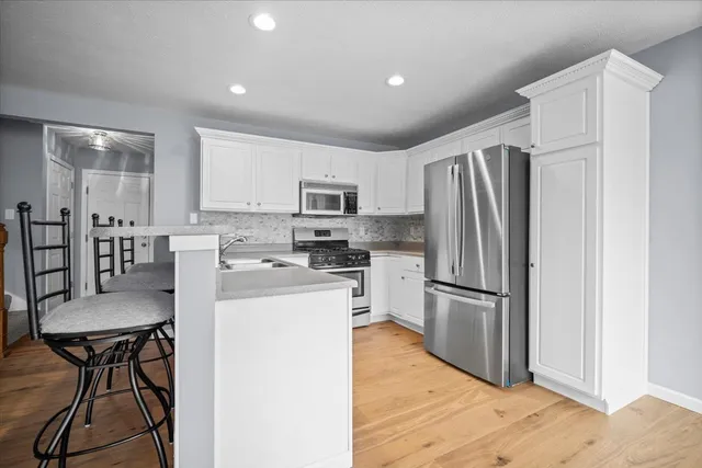 a kitchen with stainless steel appliances a refrigerator stove microwave and cabinets