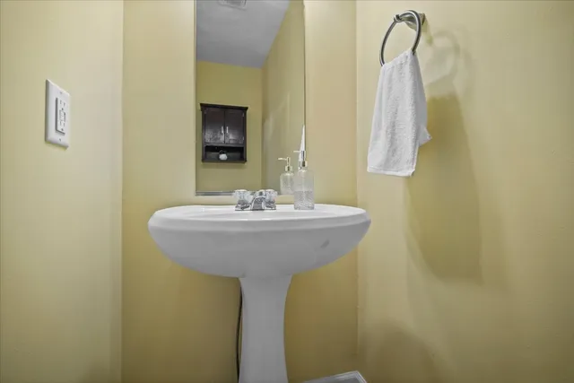 a bathroom with a sink and mirror