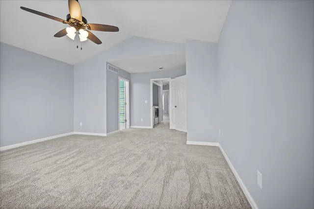 a view of a room with a ceiling fan and a chandelier fan