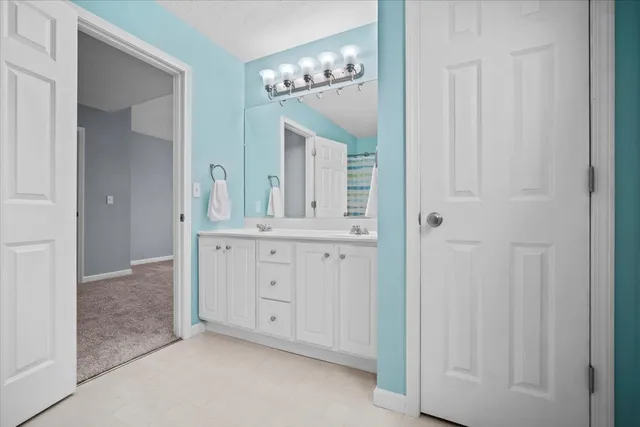 a bathroom with a toilet and a shower curtain