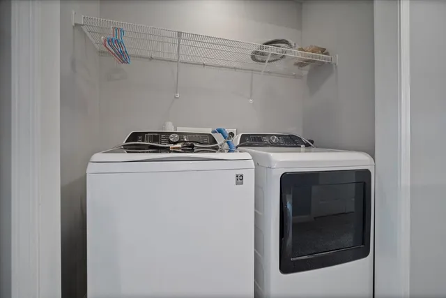 an empty room with a window and a ceiling fan