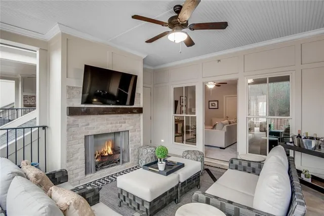 a living room with furniture and a floor to ceiling window