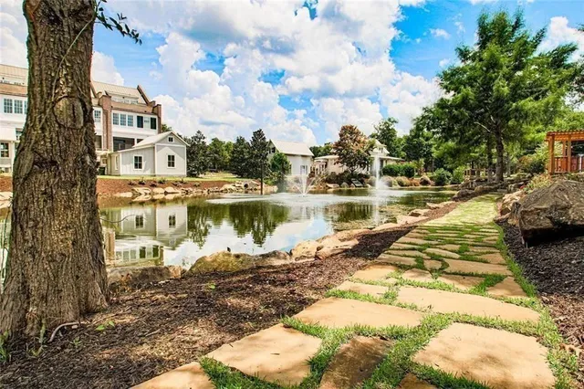 a bed room with a fireplace and floor to ceiling window