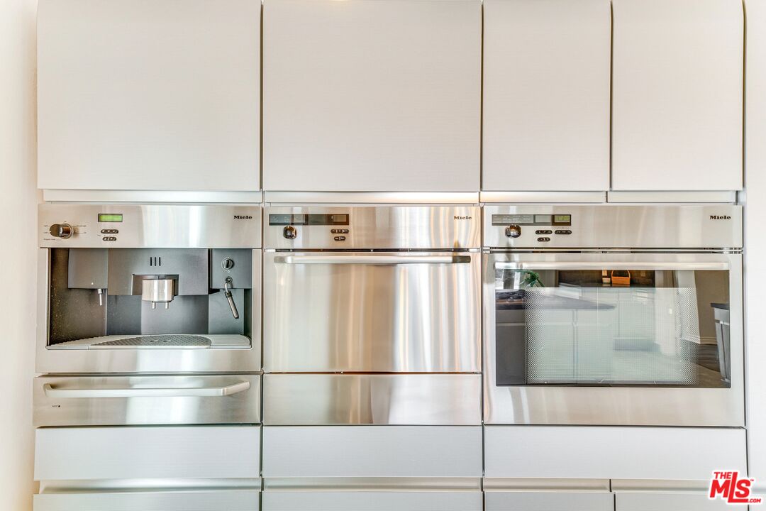 1410 Stradella Road Los Angeles, CA 90077 - Photo 12 of 42 a kitchen with kitchen island a counter top a stove and a refrigerator