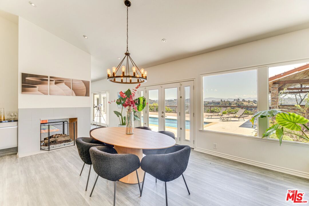 1410 Stradella Road Los Angeles, CA 90077 - Photo 14 of 42 a view of a dining room with furniture window and wooden floor