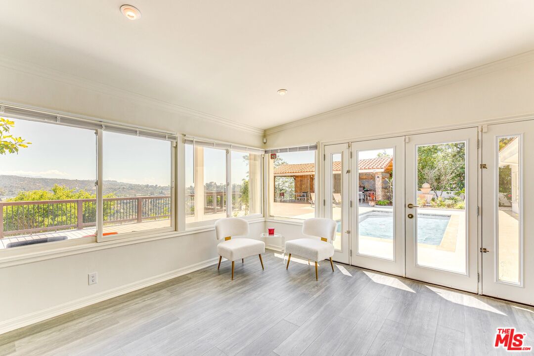 1410 Stradella Road Los Angeles, CA 90077 - Photo 15 of 42 a living room with furniture and a floor to ceiling window
