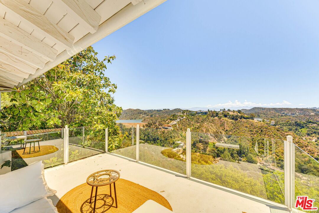 1410 Stradella Road Los Angeles, CA 90077 - Photo 19 of 42 a view of a swimming pool with a chairs