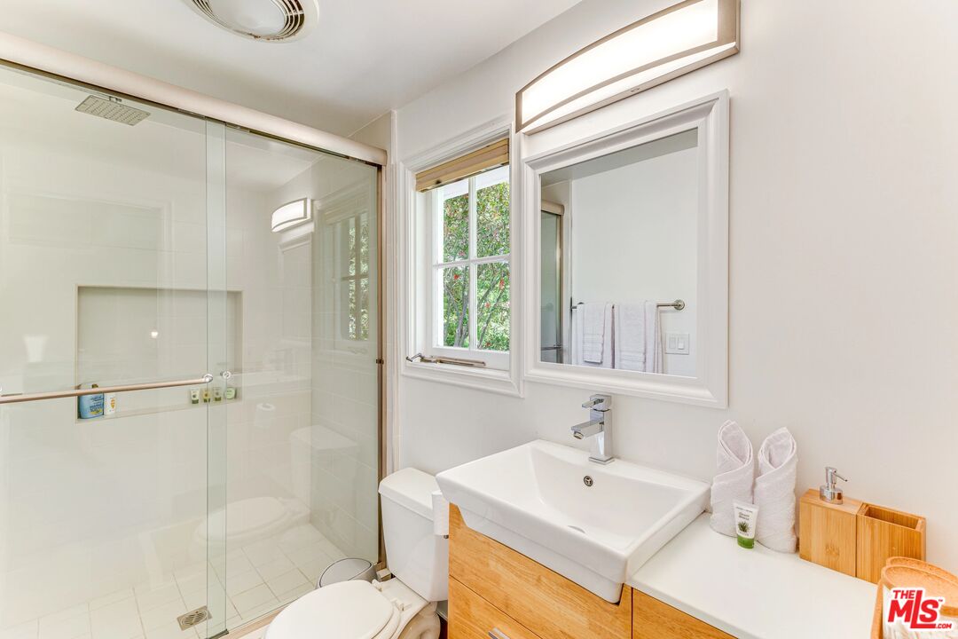 1410 Stradella Road Los Angeles, CA 90077 - Photo 22 of 42 a bathroom with a sink a toilet and shower