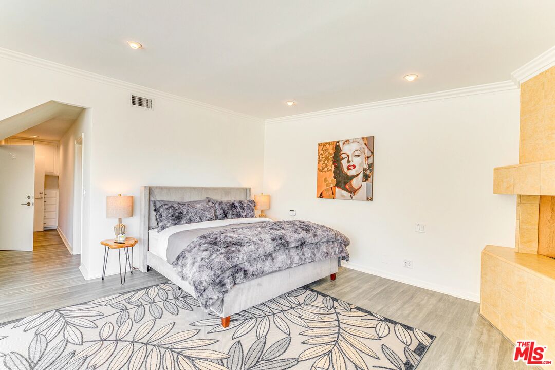 1410 Stradella Road Los Angeles, CA 90077 - Photo 25 of 42 a bedroom with a bed and a lamp on table