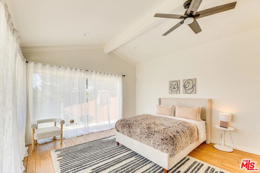1410 Stradella Road Los Angeles, CA 90077 - Photo 26 of 42 a bedroom with a bed and wooden floor