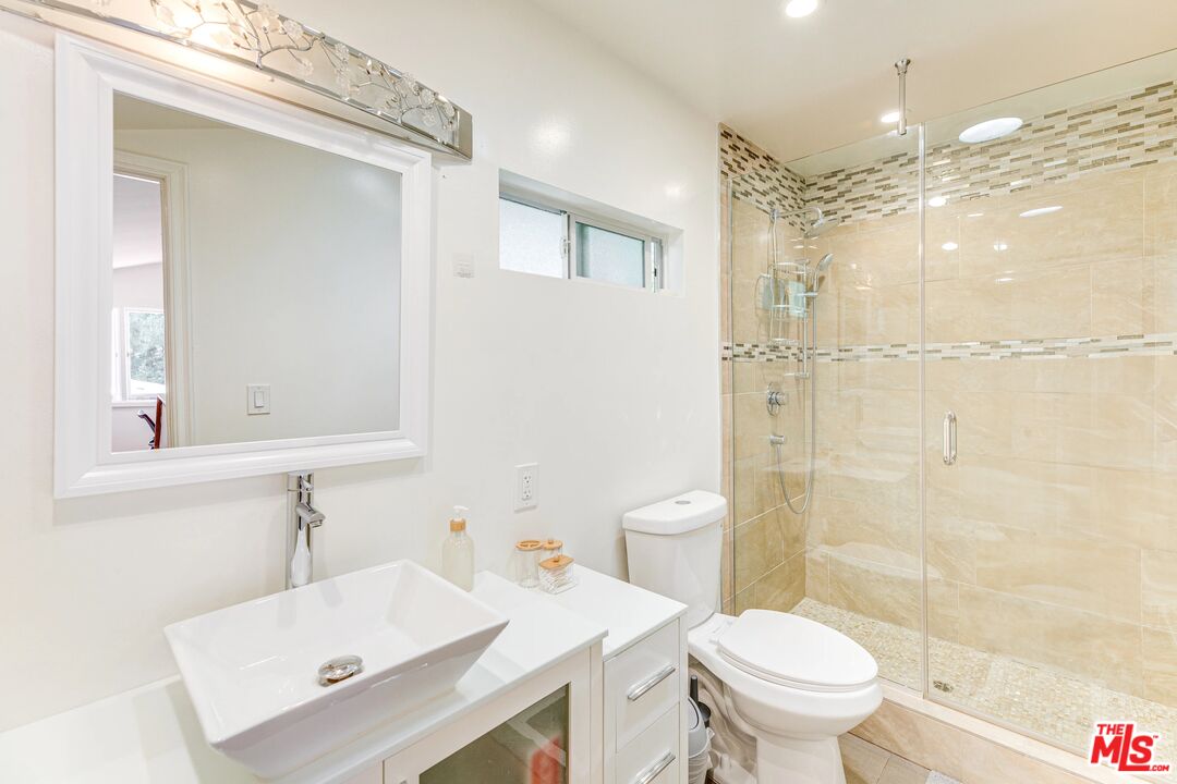 1410 Stradella Road Los Angeles, CA 90077 - Photo 31 of 42 a bathroom with a sink a toilet and shower