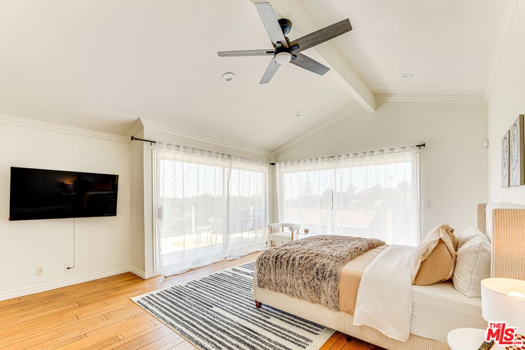 1410 Stradella Road Los Angeles, CA 90077 - Photo 35 of 42 a bedroom with a bed and a flat screen tv