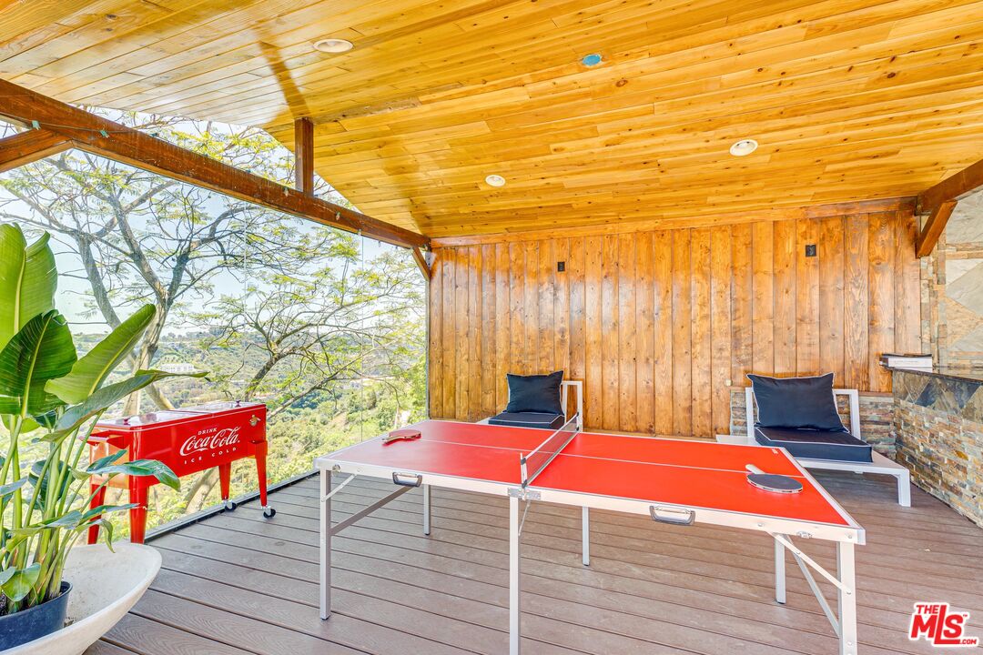 1410 Stradella Road Los Angeles, CA 90077 - Photo 38 of 42 a outdoor sitting area with furniture and wooden floor
