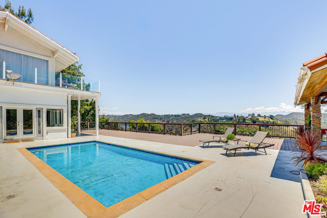 1410 Stradella Road Los Angeles, CA 90077 - Photo 40 of 42 a view of a swimming pool with lounge chair