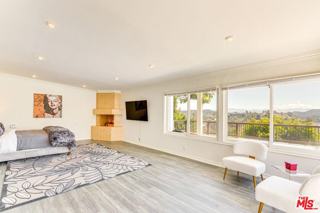 1410 Stradella Road Los Angeles, CA 90077 - Photo 6 of 42 a bedroom with furniture and a large window