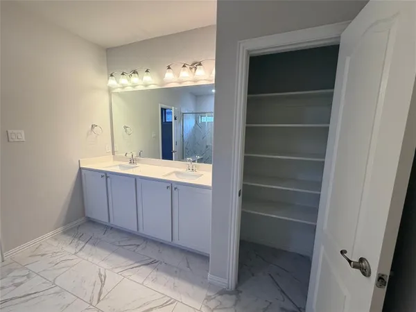 a bathroom with a double vanity sink and a mirror