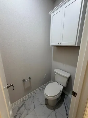 a white toilet sitting next to a bathroom sink