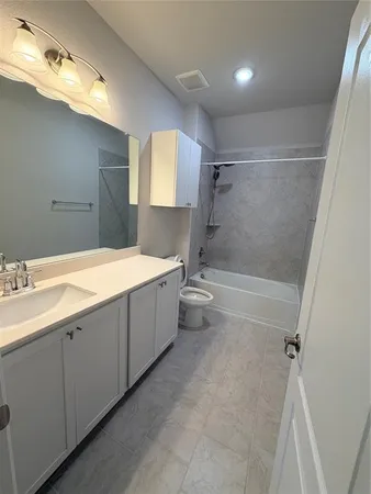 a bathroom with a double vanity sink toilet mirror and bathtub