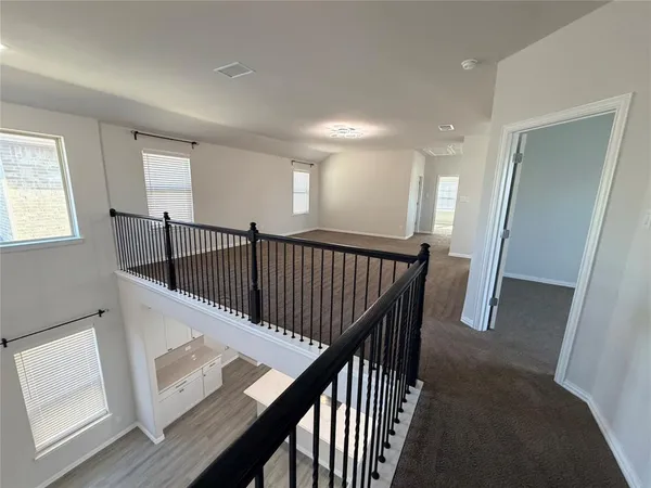a view of staircase with railing and white walls
