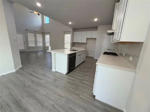 a kitchen with a sink and a stove top oven
