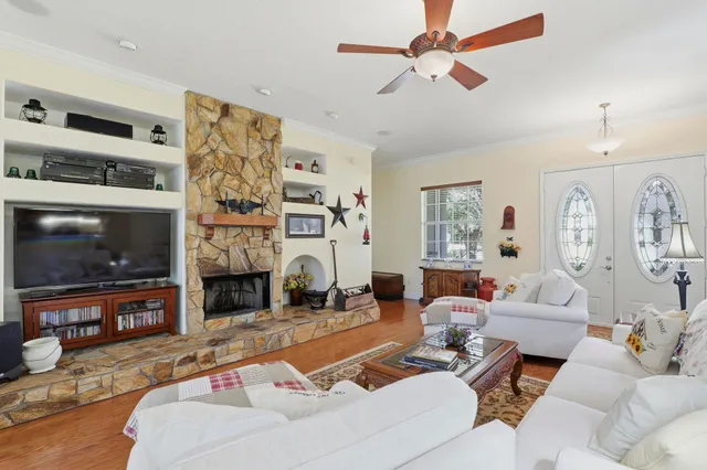 a living room with furniture a rug and a window