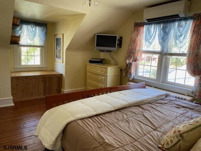 2106 Shore Road Northfield, NJ 08225 - Photo 22 of 44 a bedroom with a bed and wooden floor